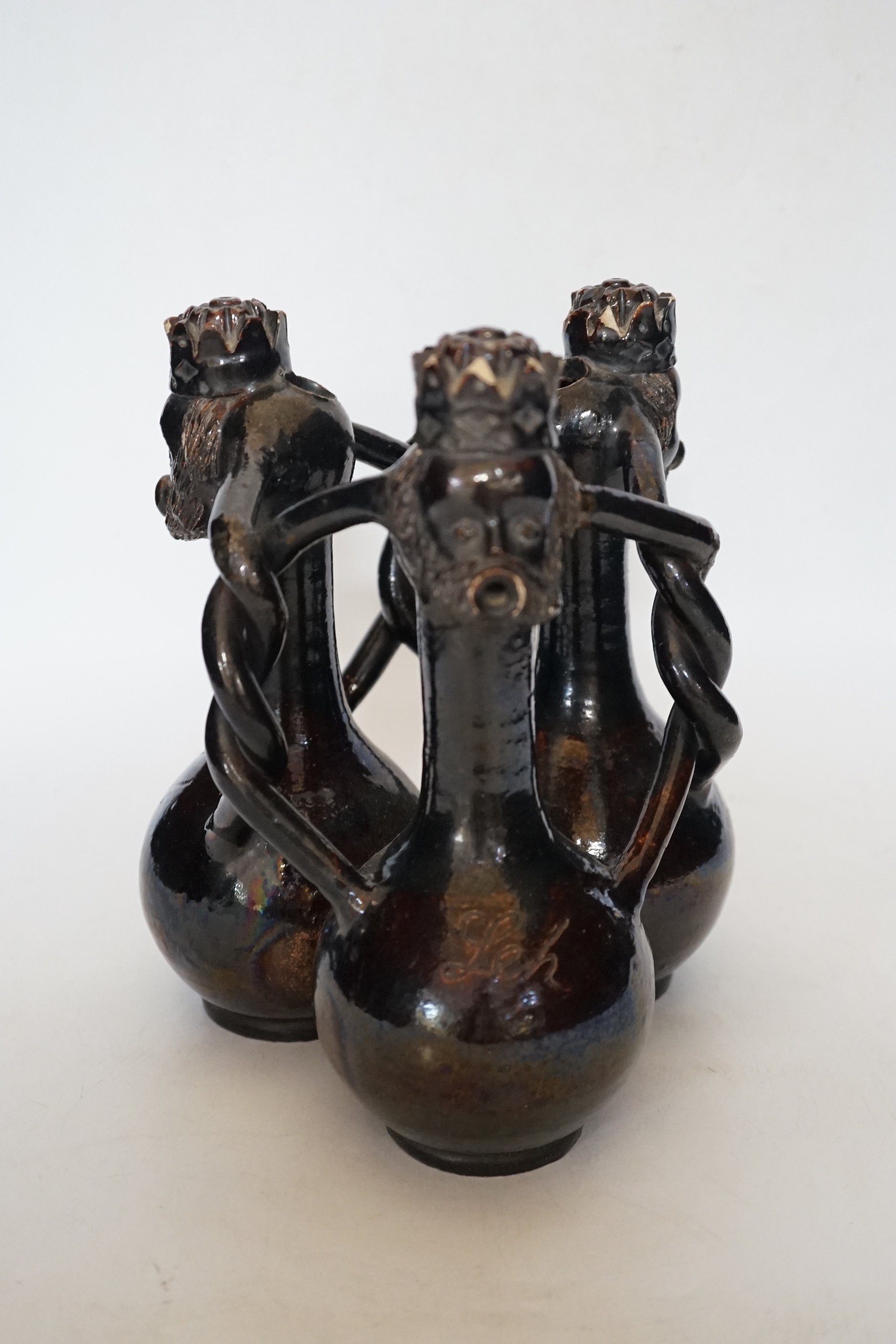 A Slavonic three section brown glazed earthenware puzzle jug and pair of 19th century Portuguese lizard handle maiolica vases and two other similar items, largest 28cm high